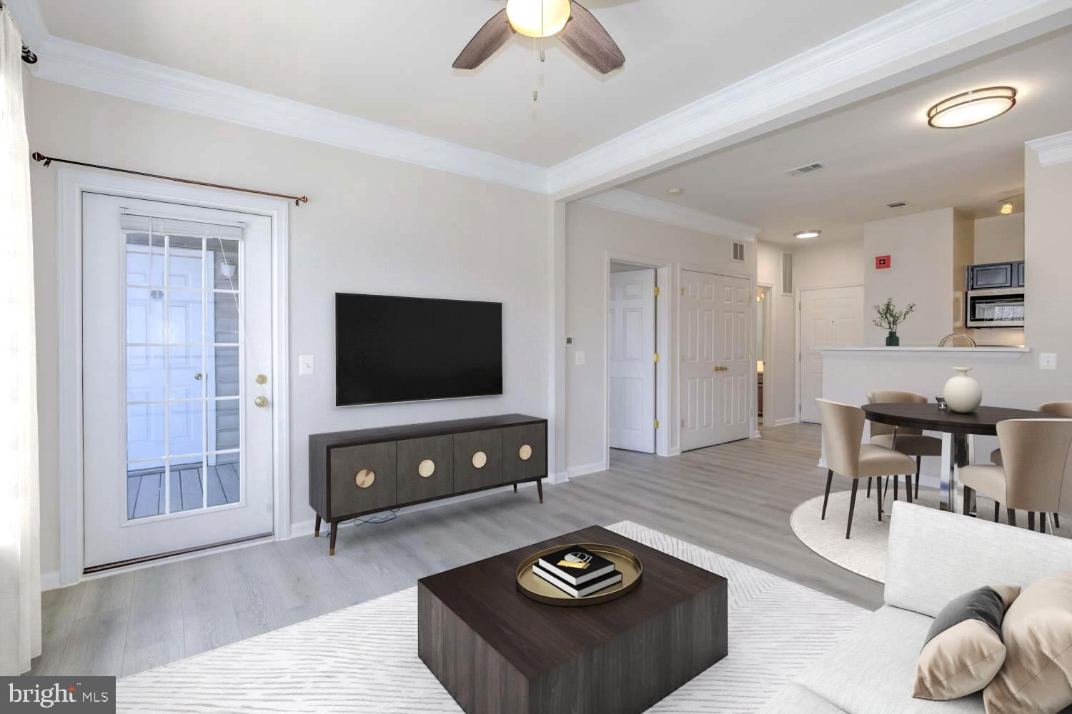 1530 Spring Gate Dr., Unit 9213 McLean, VA 22102 - Photo 3 of 24 a living room with furniture and a flat screen tv