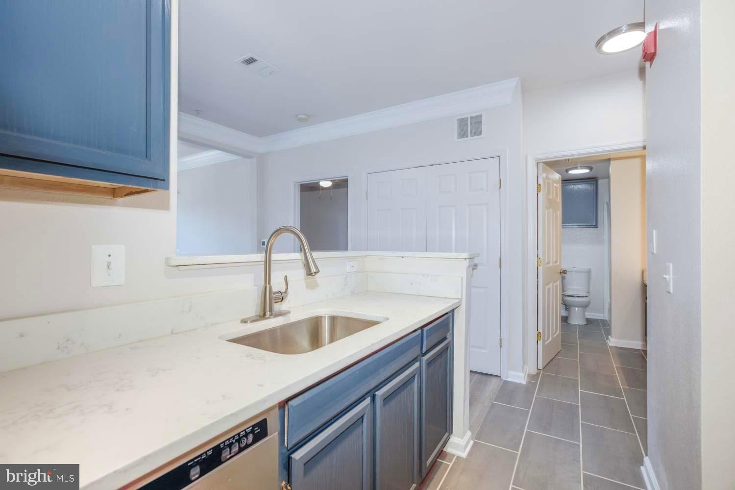 1530 Spring Gate Dr., Unit 9213 McLean, VA 22102 - Photo 7 of 24 a kitchen with a sink and a refrigerator