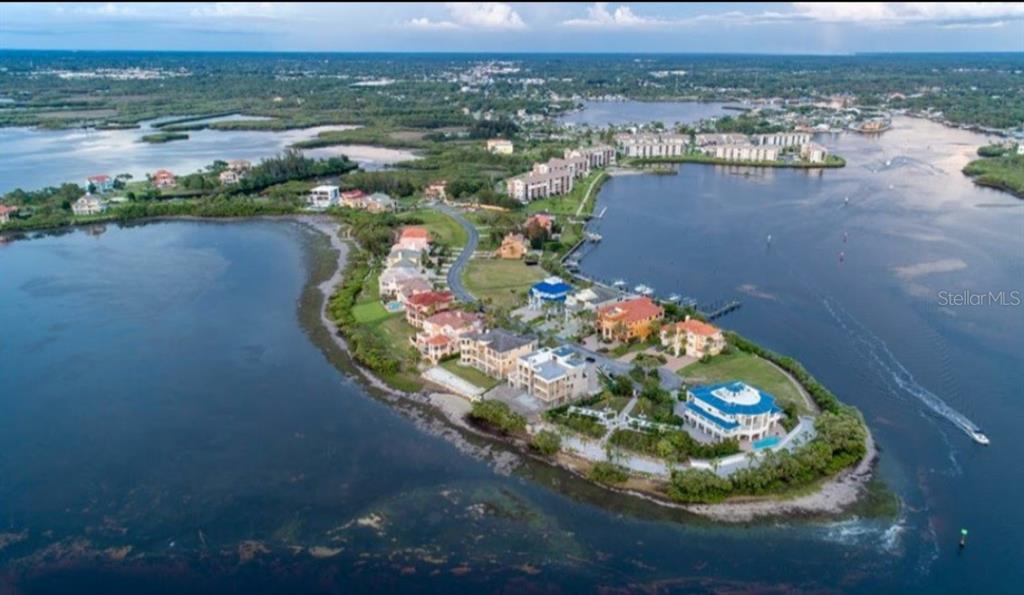 25 Harborpointe Drive Port Richey, FL 34668 - Photo 14 of 21 an aerial view of a house with a yard and lake