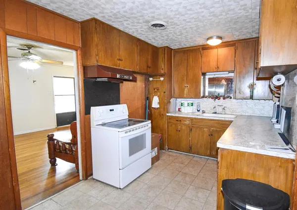 a kitchen that has a sink and a stove in it