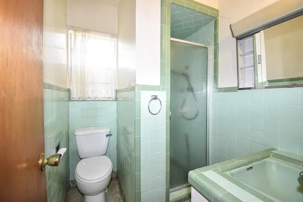 a bathroom with a toilet sink vanity and tub