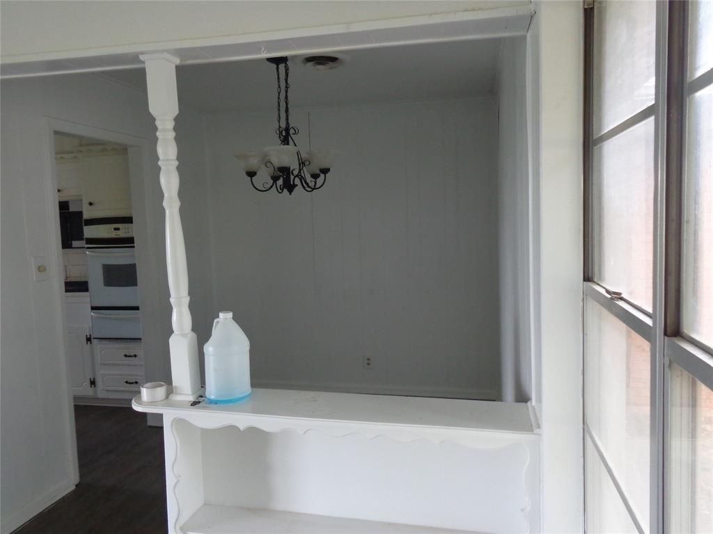 612 South Files Street Itasca, TX 76055 - Photo 14 of 30 Bathroom featuring a chandelier and dark wood finished floors