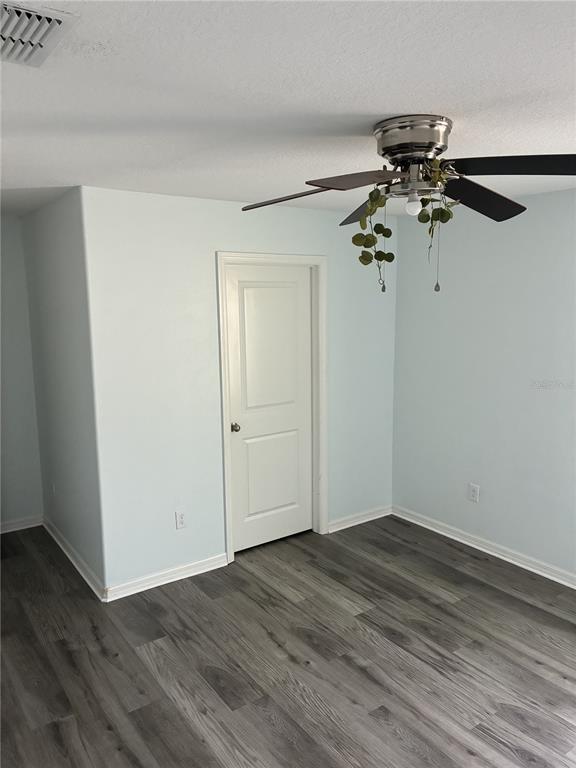 9616 Lemon Drop Loop Sun City Center, FL 33573 - Photo 31 of 53 a view of a room with wooden floor cabinet and a ceiling fan