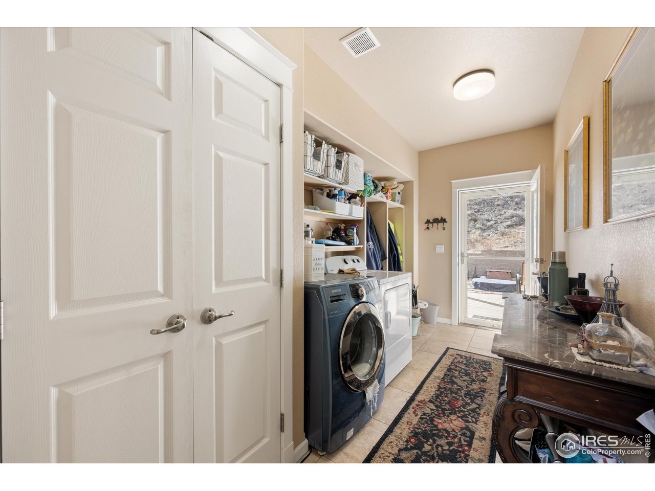 229 Rustic Road Bellvue, CO 80512 - Photo 31 of 50 a living room with furniture a flat screen tv and a refrigerator