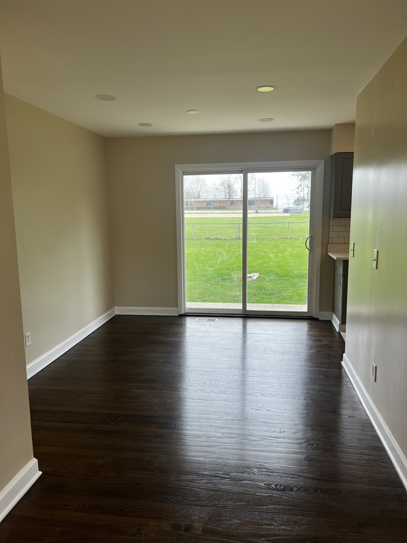 281 Chicago Road Oswego, IL 60543 - Photo 11 of 16 a view of empty room with wooden floor and fan