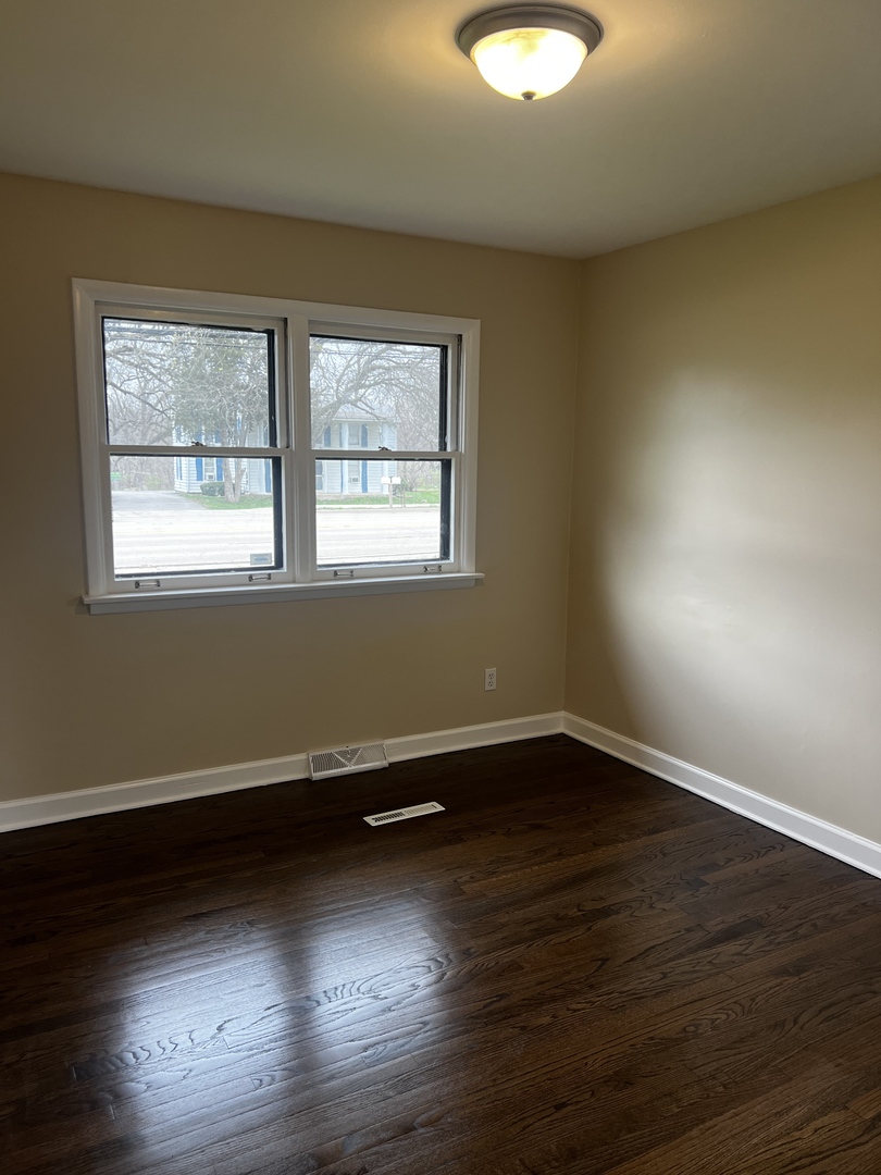281 Chicago Road Oswego, IL 60543 - Photo 14 of 16 an empty room with wooden floor and windows