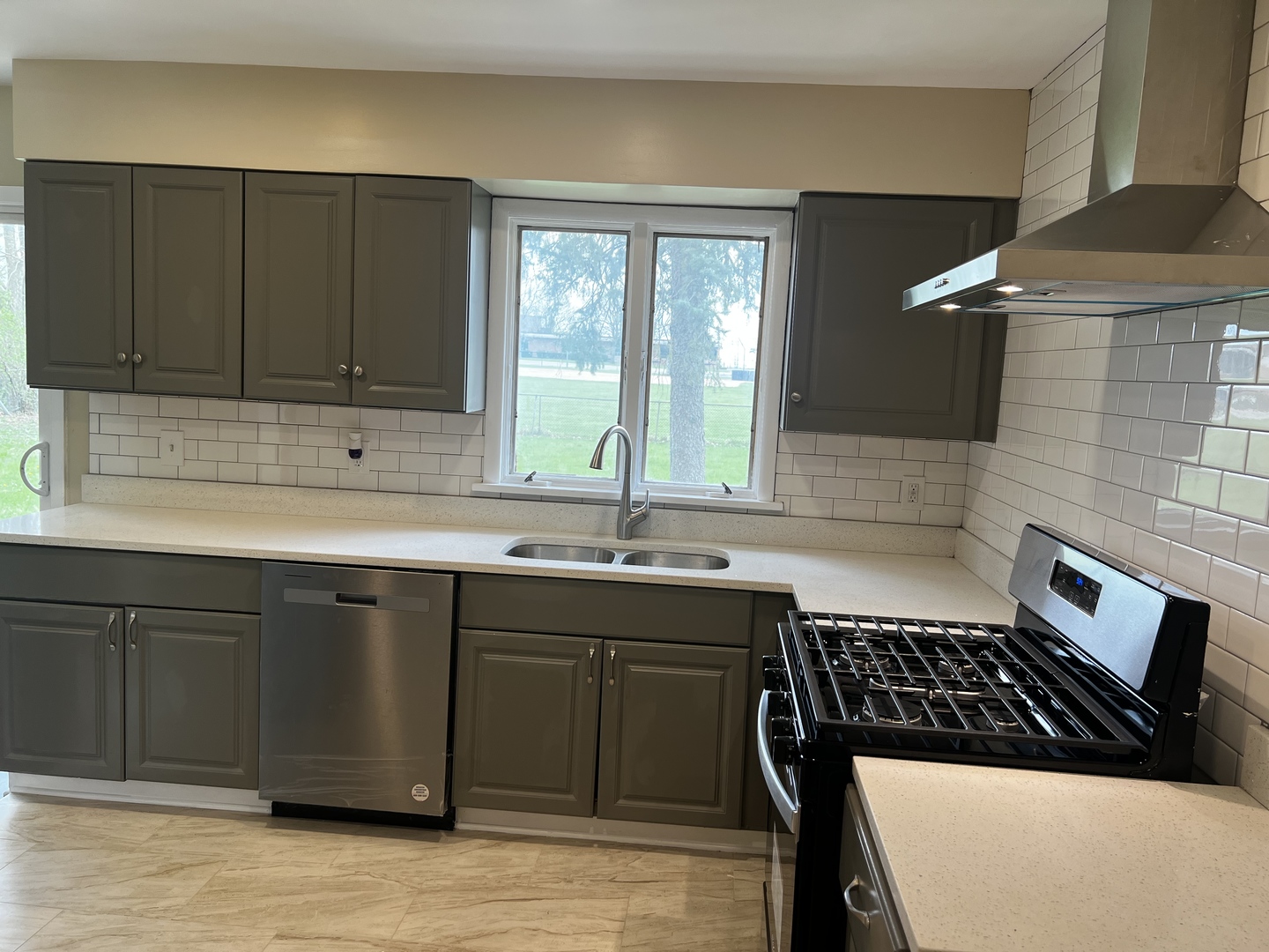 281 Chicago Road Oswego, IL 60543 - Photo 8 of 16 a kitchen with a sink stove and cabinets