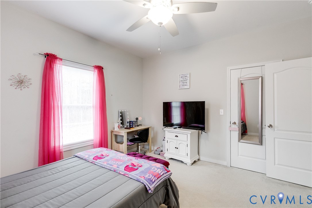 10525 Amelia Springs Road Jetersville, VA 23083 - Photo 12 of 25 a bedroom with a bed and a flat screen tv