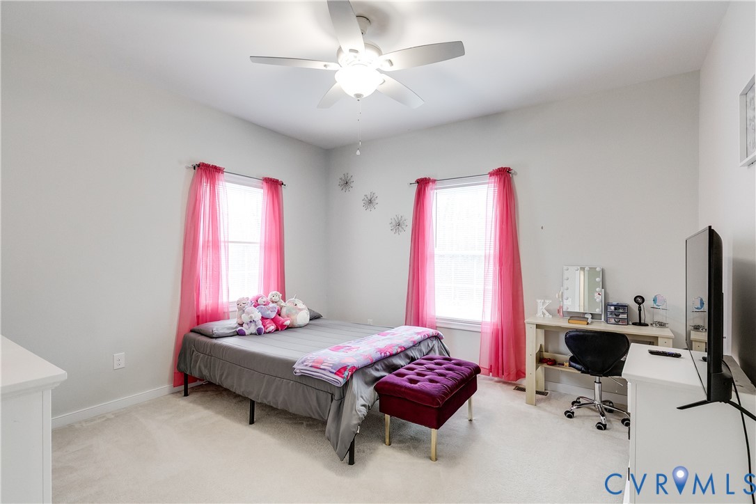 10525 Amelia Springs Road Jetersville, VA 23083 - Photo 13 of 25 a bedroom with a bed and a chandelier