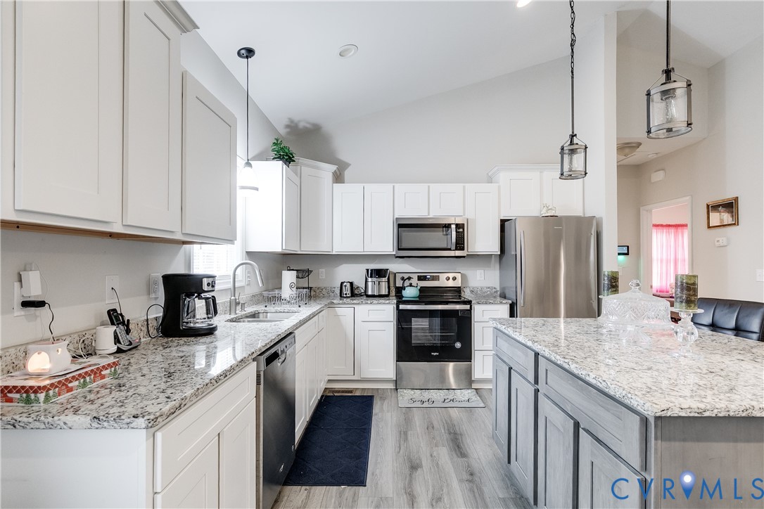 10525 Amelia Springs Road Jetersville, VA 23083 - Photo 17 of 25 a kitchen with kitchen island granite countertop a sink counter top space appliances and cabinets
