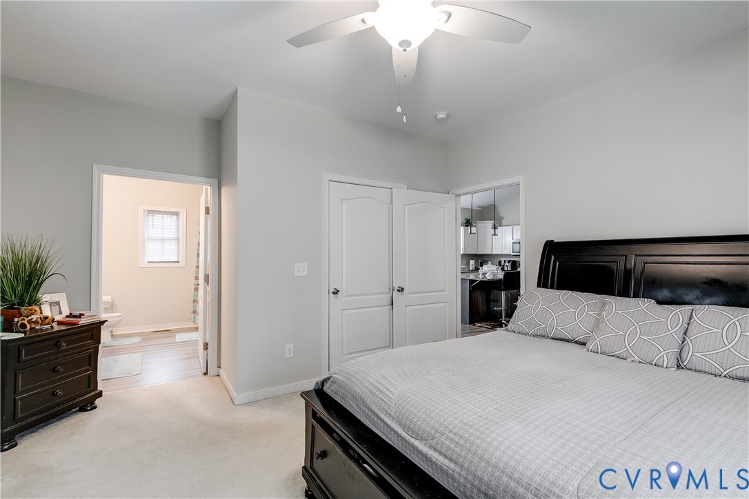 10525 Amelia Springs Road Jetersville, VA 23083 - Photo 3 of 25 a bedroom with a bed and a chandelier