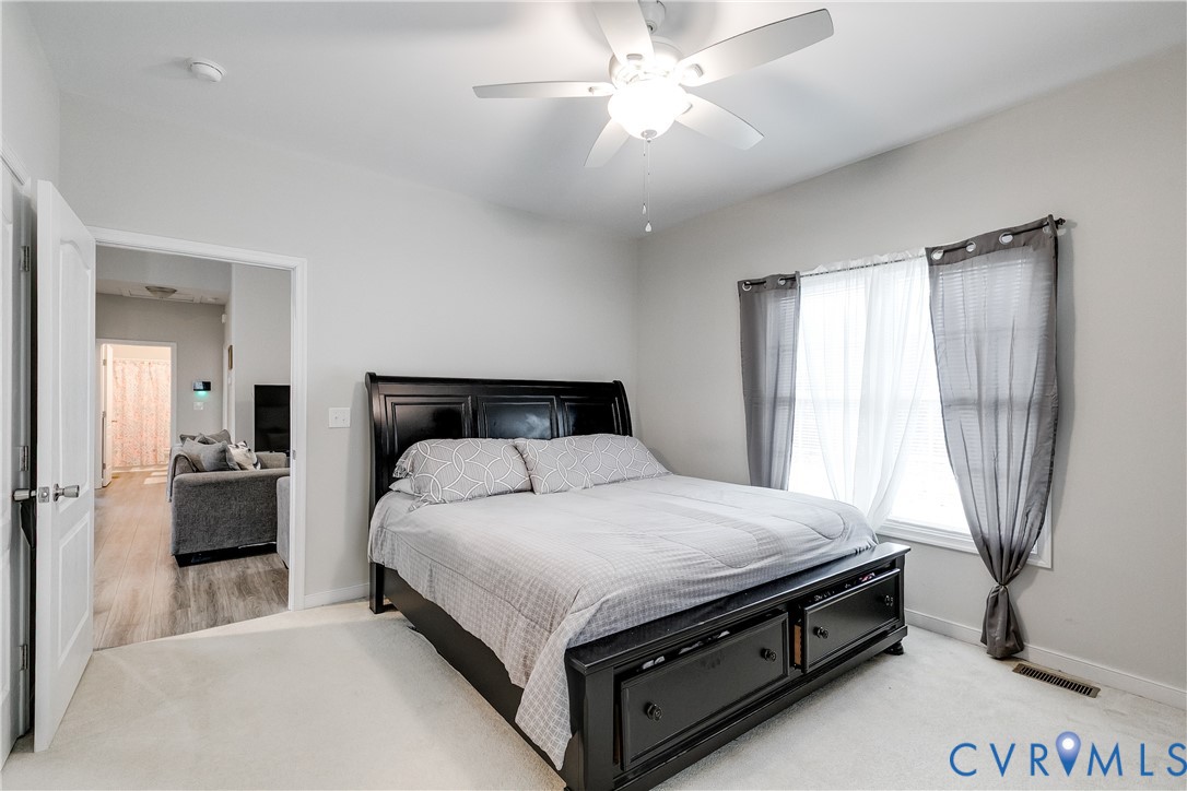 10525 Amelia Springs Road Jetersville, VA 23083 - Photo 4 of 25 a bedroom with a bed and a chandelier