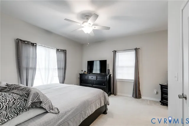 a bedroom with a bed and a flat tv screen