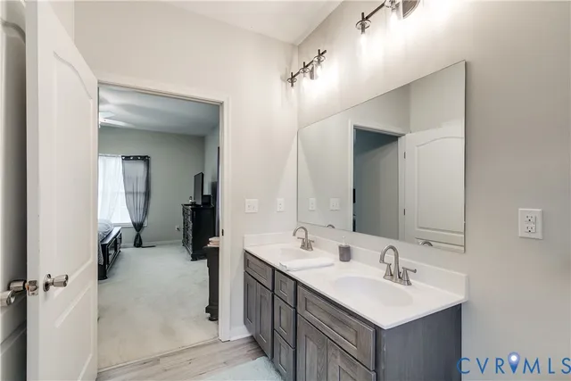 a bathroom with a double vanity sink a mirror and shower
