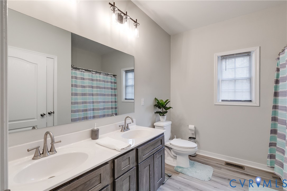 10525 Amelia Springs Road Jetersville, VA 23083 - Photo 9 of 25 a bathroom with a granite countertop sink toilet and a mirror