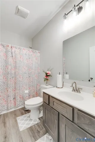 a bathroom with a sink toilet and a mirror