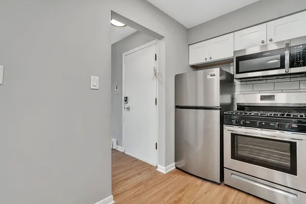 a kitchen with a refrigerator stove and microwave