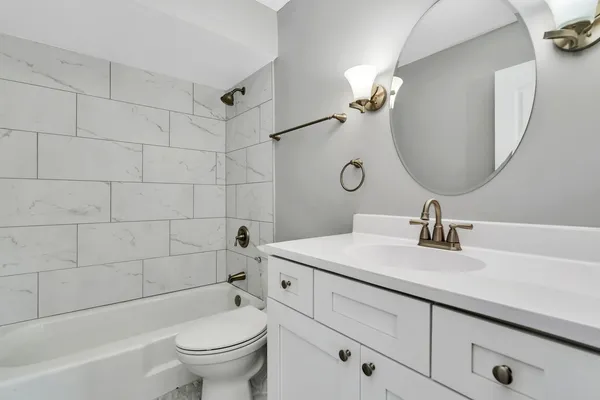 a bathroom with a sink a toilet and a mirror