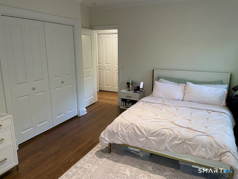 9 Tory Hole Road Darien, CT 06820 - Photo 24 of 33 a bedroom with a bed and wooden floor