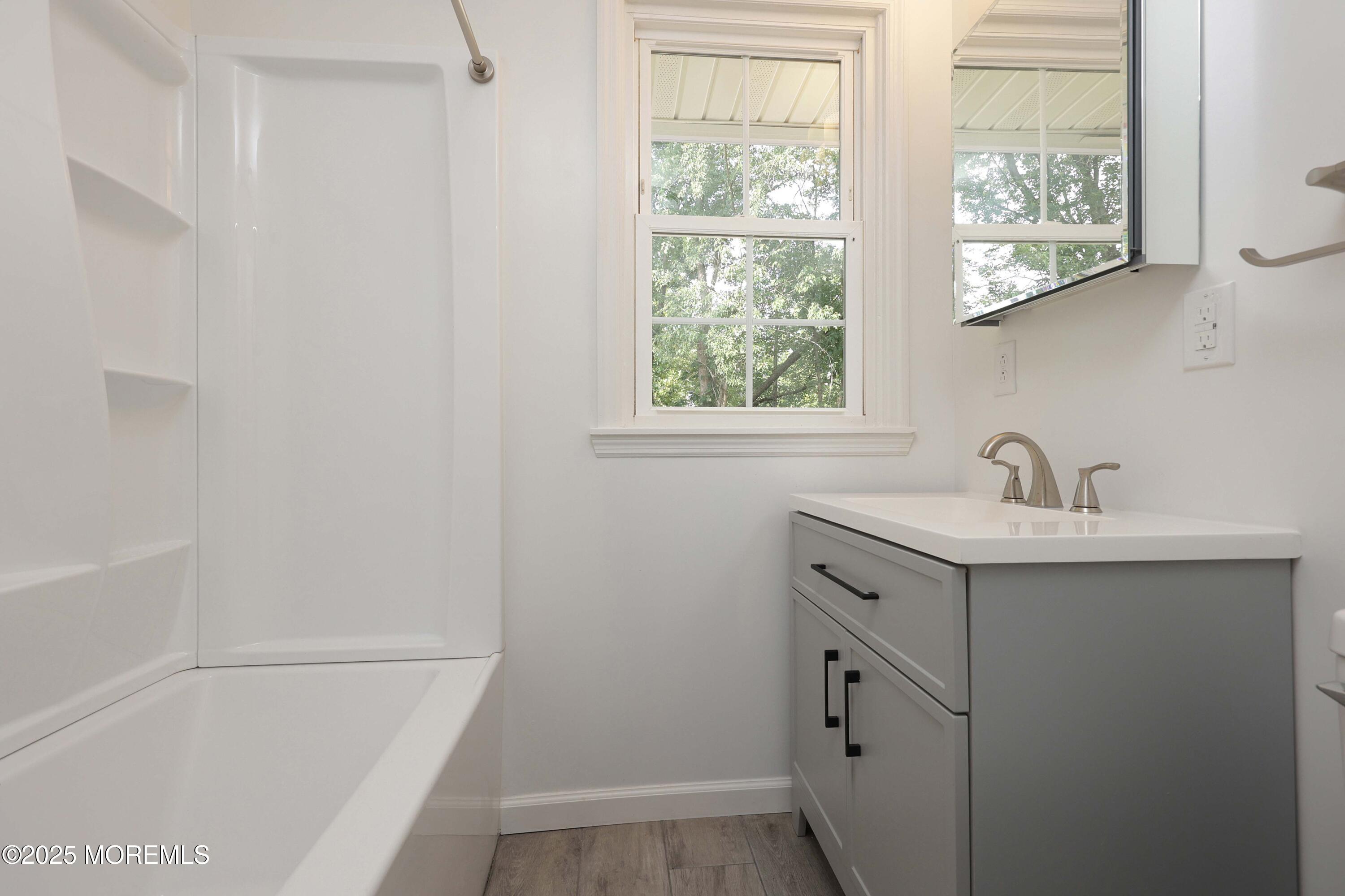 912 Pemberton Browns Mills Road Pemberton, NJ 08068 - Photo 12 of 28 a bathroom with a sink a vanity and a bathtub