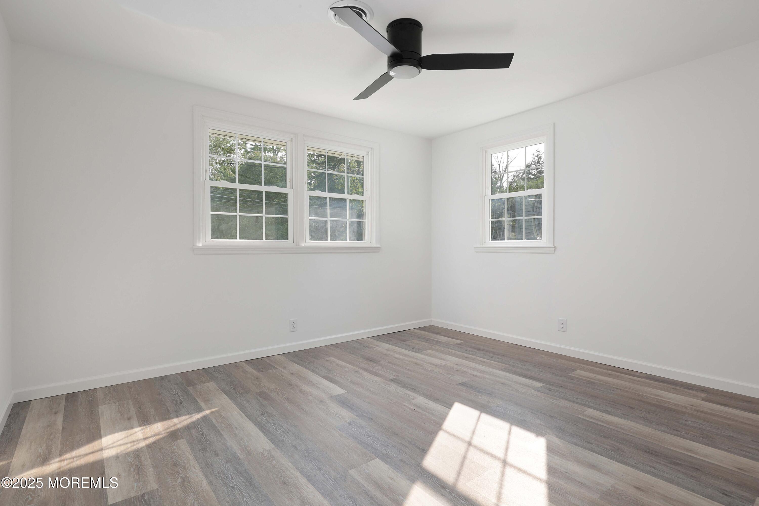 912 Pemberton Browns Mills Road Pemberton, NJ 08068 - Photo 14 of 28 an empty room with wooden floor and windows