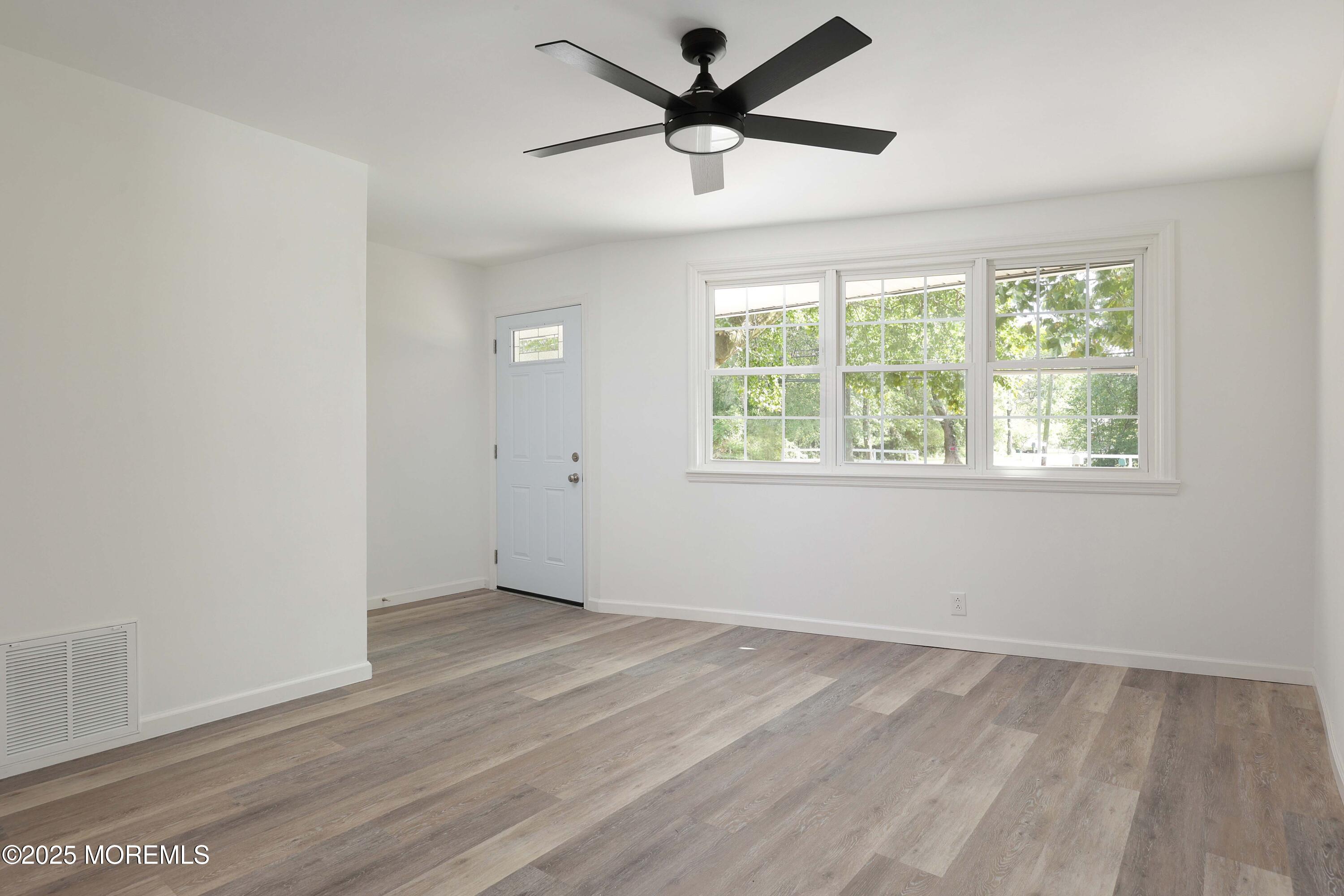 912 Pemberton Browns Mills Road Pemberton, NJ 08068 - Photo 6 of 28 an empty room with wooden floor and windows