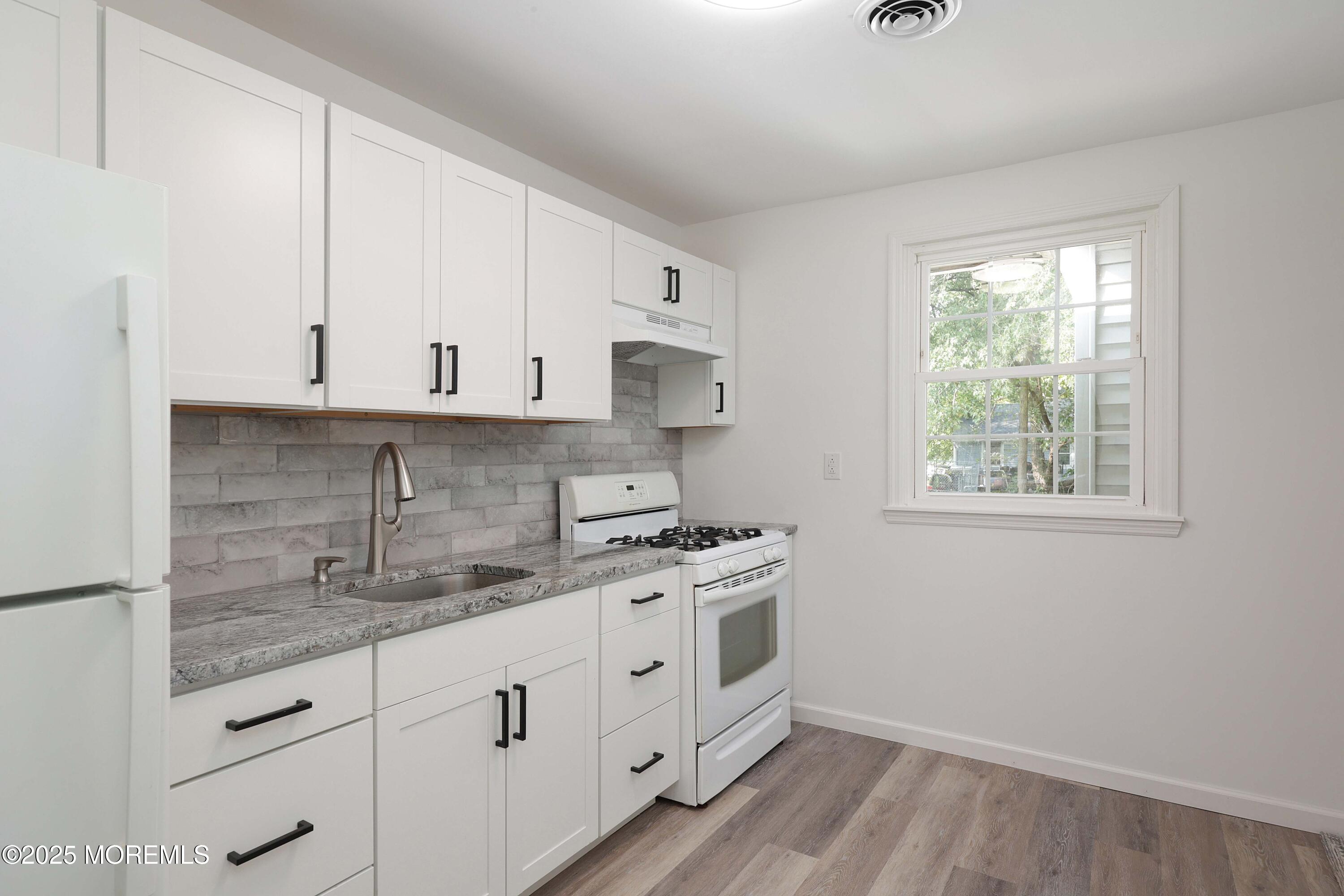 912 Pemberton Browns Mills Road Pemberton, NJ 08068 - Photo 9 of 28 a kitchen with stainless steel appliances granite countertop white cabinets and a stove top oven