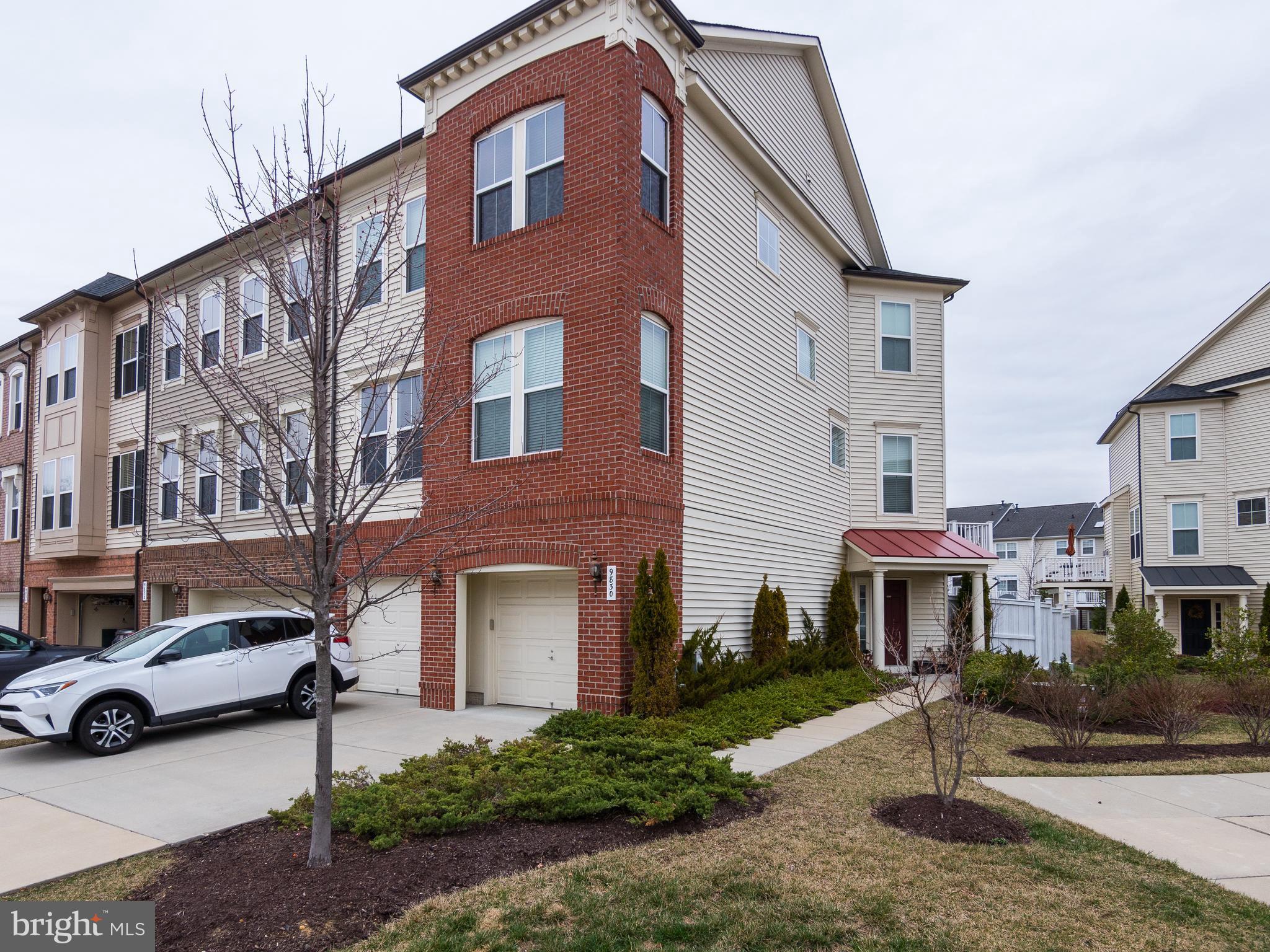 9830 Garden Ranges Laurel, MD 20723 - Photo 2 of 34 a front view of a residential apartment building with a yard