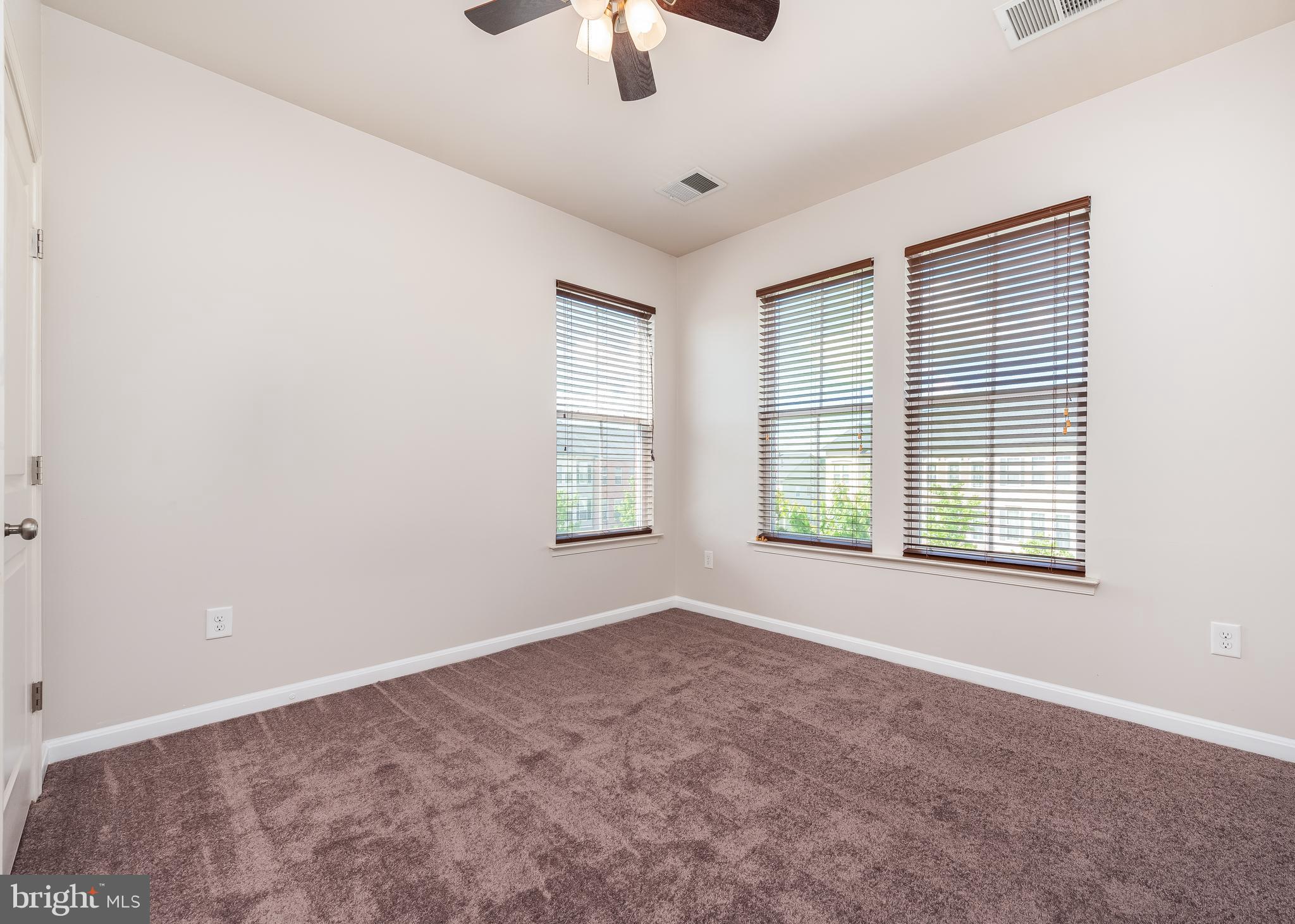 9830 Garden Ranges Laurel, MD 20723 - Photo 23 of 34 an empty room with a window and a ceiling fan
