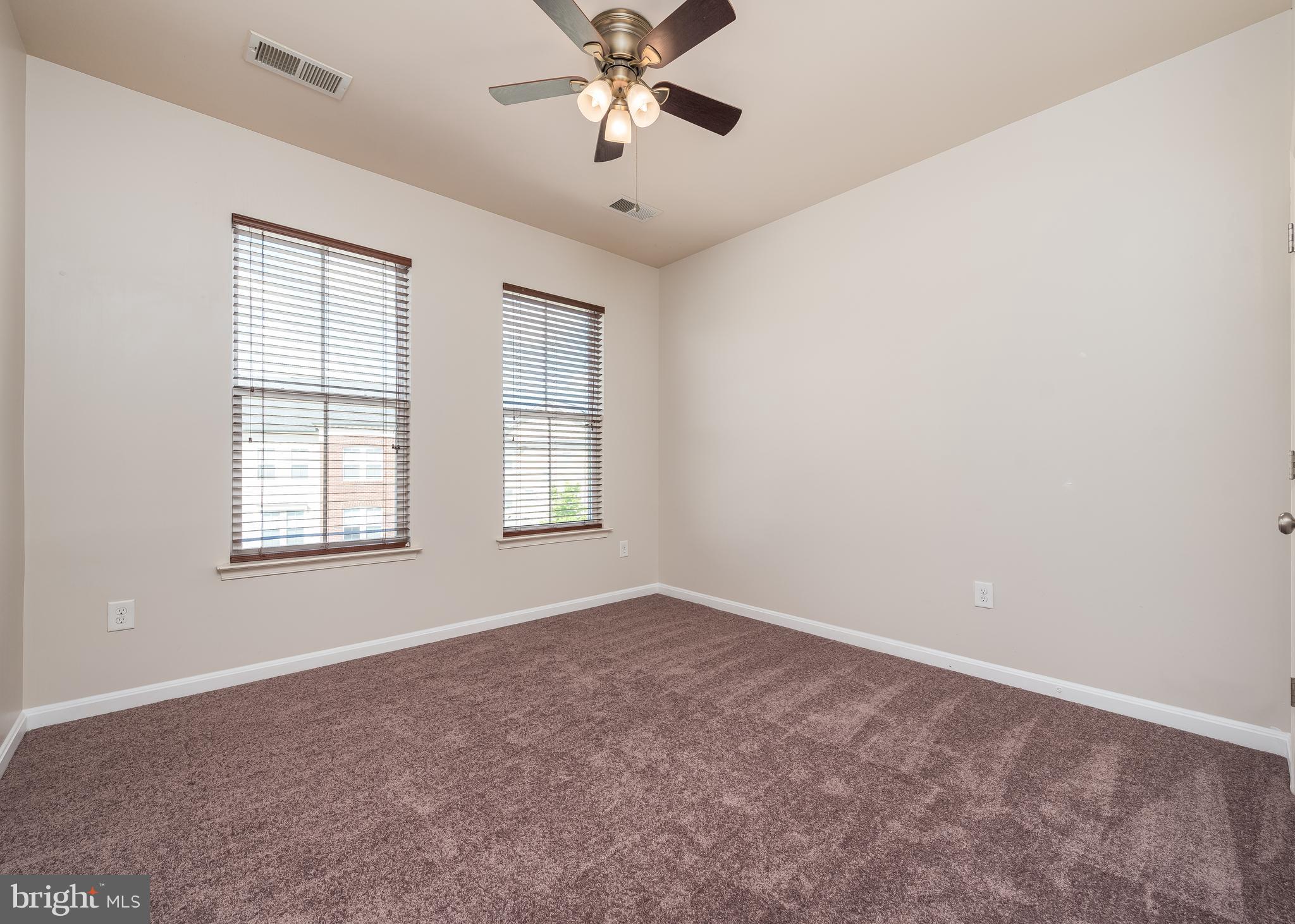 9830 Garden Ranges Laurel, MD 20723 - Photo 24 of 34 an empty room with windows and fan