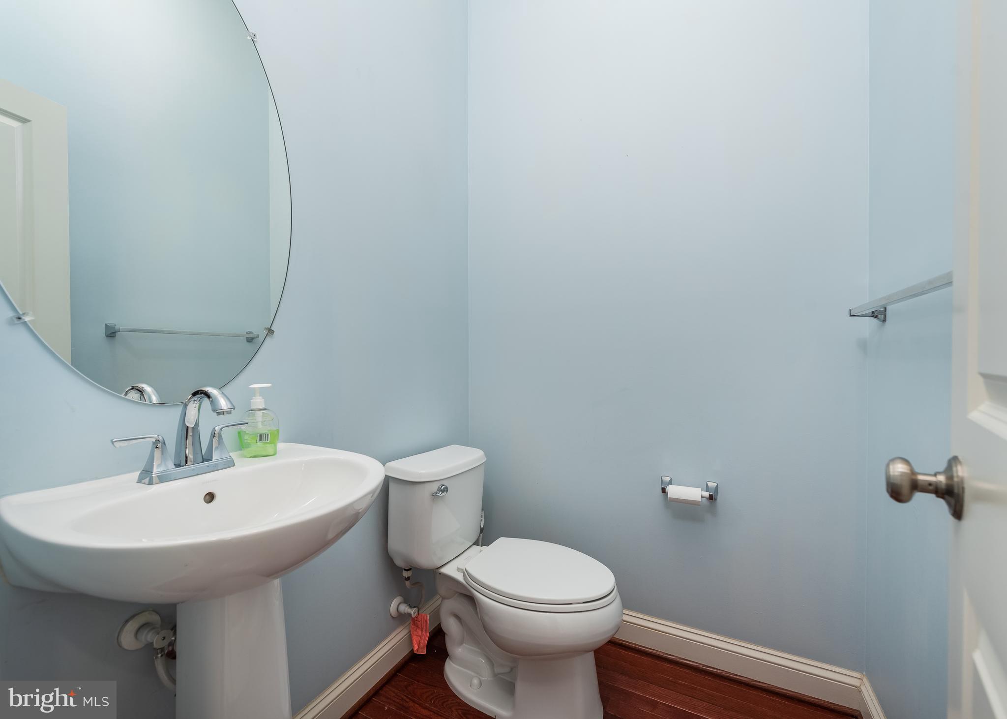 9830 Garden Ranges Laurel, MD 20723 - Photo 7 of 34 a bathroom with a sink toilet and a mirror