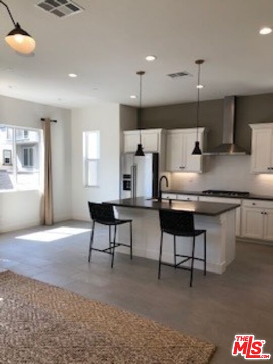 527 Daniel Freeman Circle Inglewood, CA 90301 - Photo 11 of 36 a living room with kitchen island furniture and a wooden floor