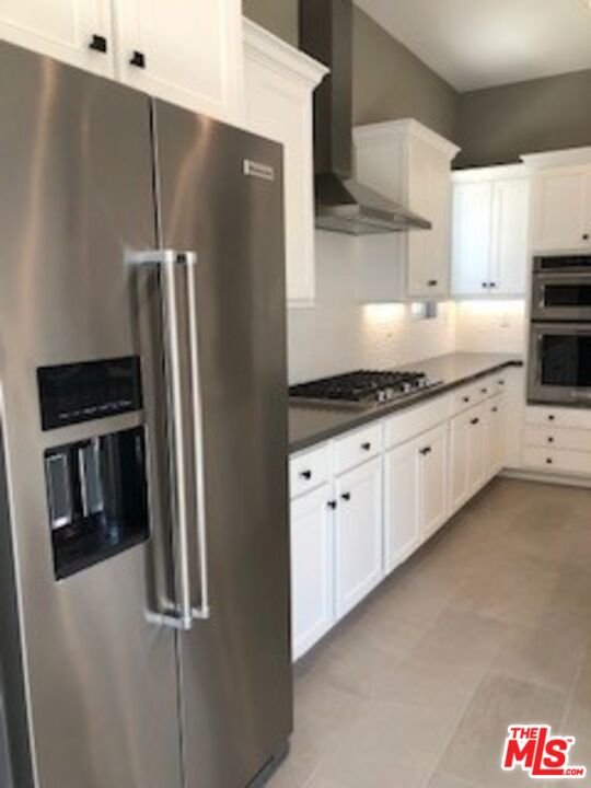 527 Daniel Freeman Circle Inglewood, CA 90301 - Photo 13 of 36 a kitchen with granite countertop a refrigerator and a sink
