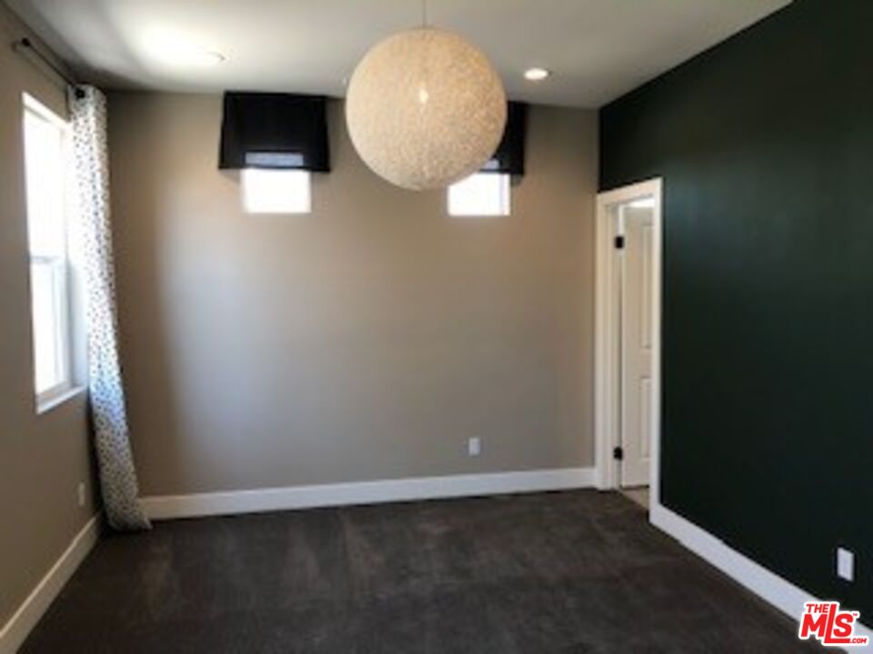 527 Daniel Freeman Circle Inglewood, CA 90301 - Photo 28 of 36 an empty room with wooden floor and windows