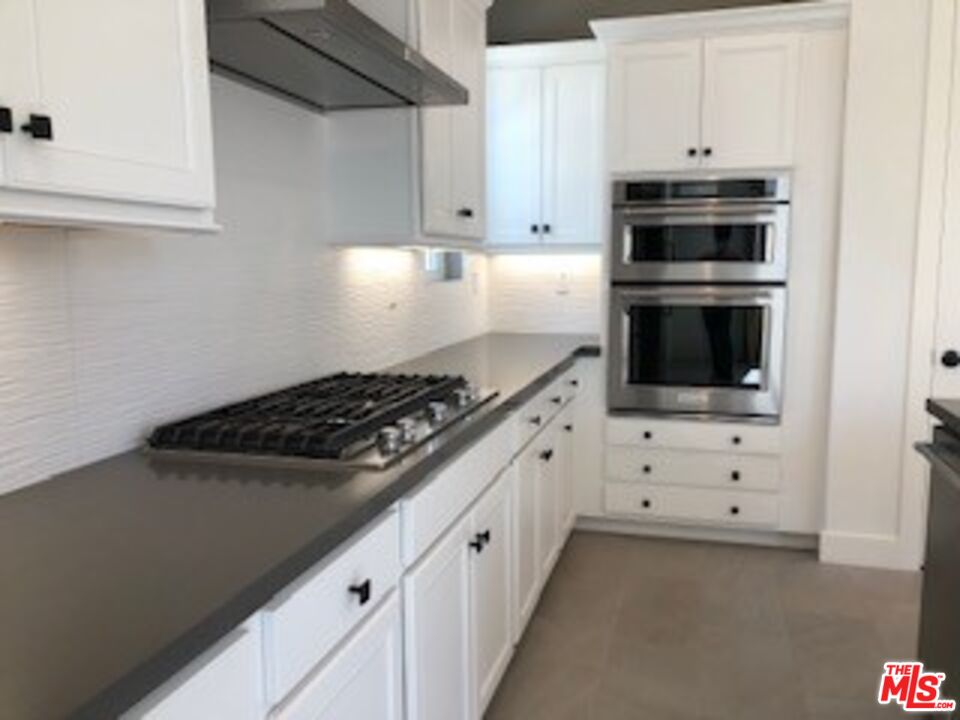 527 Daniel Freeman Circle Inglewood, CA 90301 - Photo 30 of 36 a kitchen with stainless steel appliances a stove and a refrigerator