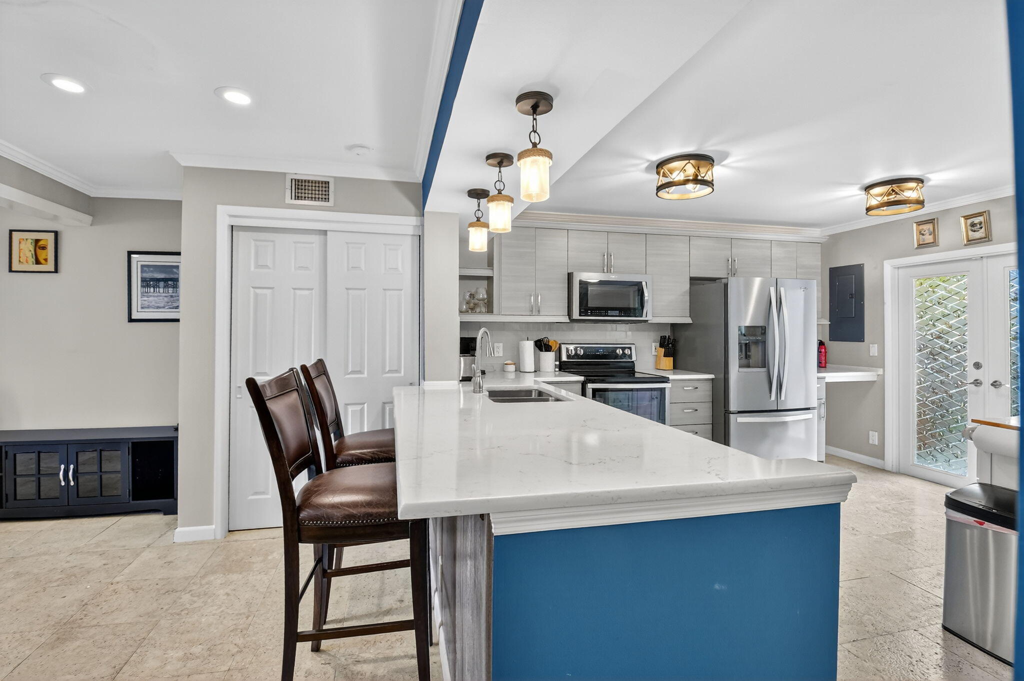 732 Rider Road Boynton Beach, FL 33435 - Photo 20 of 66 a kitchen with stainless steel appliances kitchen island granite countertop a refrigerator a stove a microwave oven a sink with island and chairs