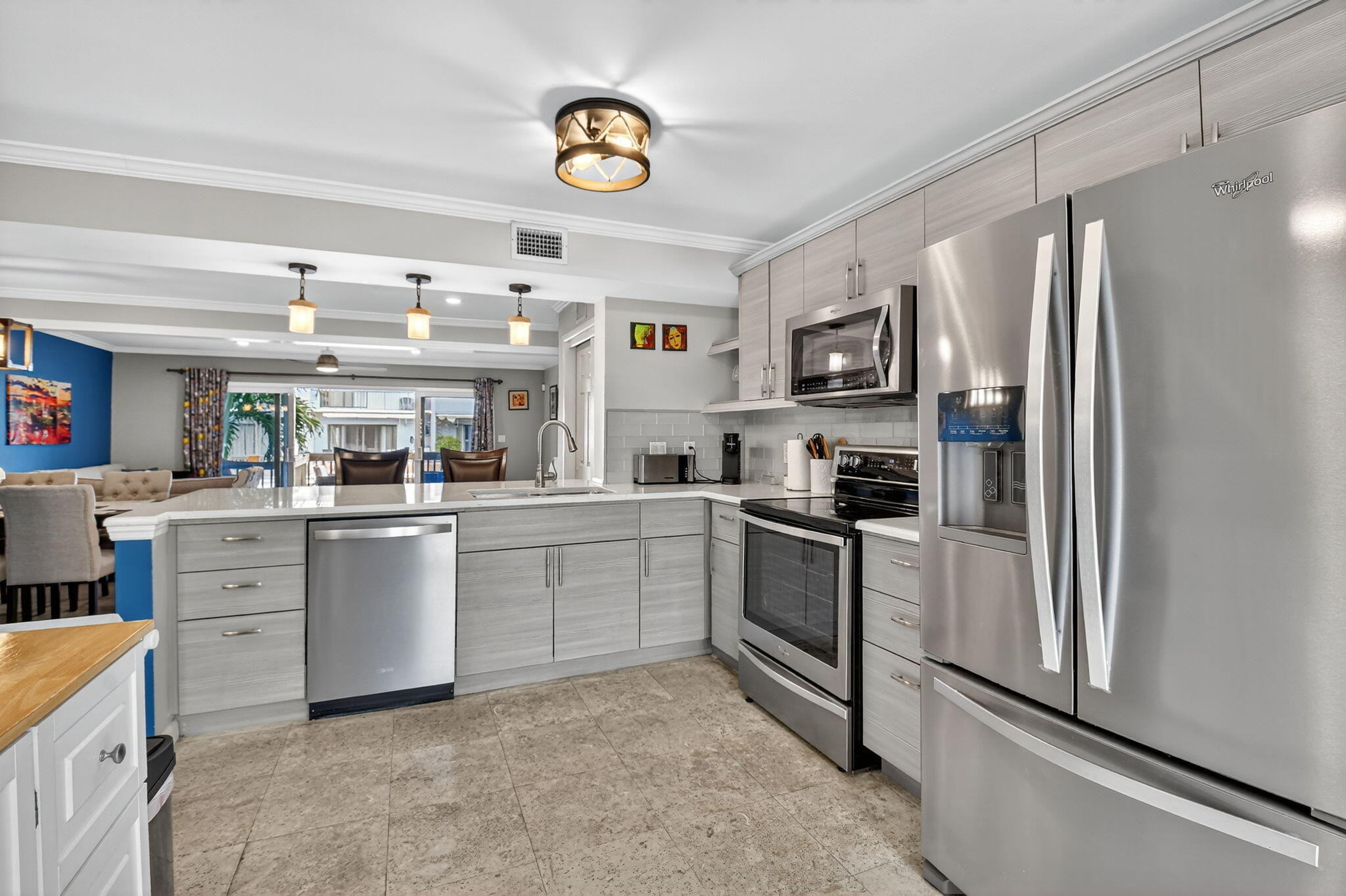 732 Rider Road Boynton Beach, FL 33435 - Photo 25 of 66 a kitchen with cabinets and stainless steel appliances