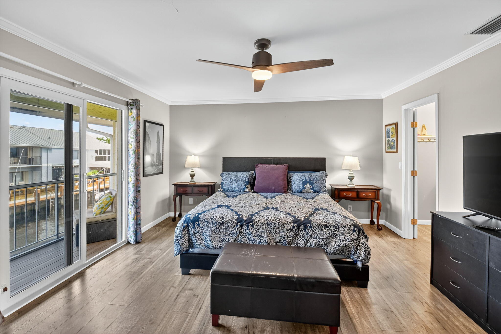 732 Rider Road Boynton Beach, FL 33435 - Photo 34 of 66 a bedroom with a large bed and a flat tv screen