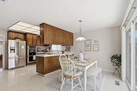 a kitchen with a table and chairs in it