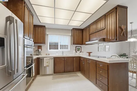 a kitchen with a sink stove and refrigerator