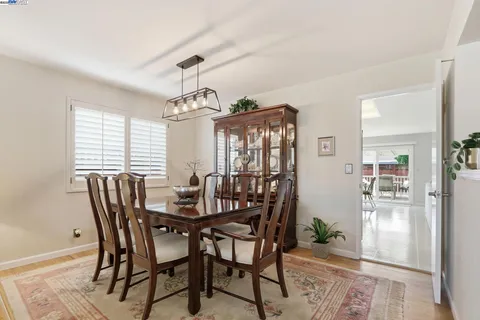 a dining room with furniture window and wooden floor
