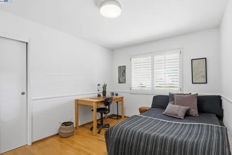 a bedroom with a bed and a desk