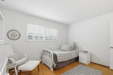 a bedroom with a bed and a chair