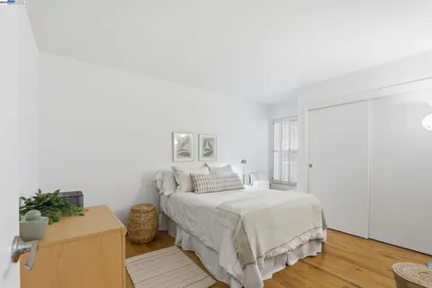 a bedroom with a bed table and a couch