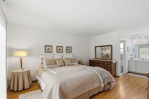 a bedroom with a bed and a night stand