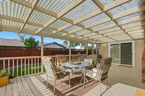 a view of a chairs and table in the patio