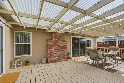 a patio with patio area table and chairs
