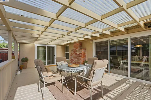 a view of a house with a yard and deck