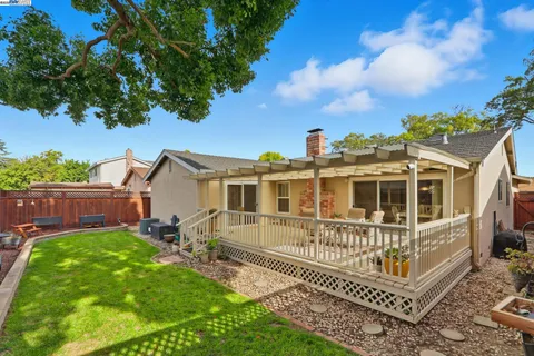 a view of a chair and table in backyard