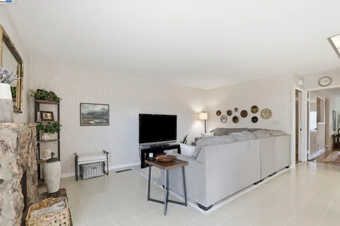 a view of a workspace with furniture and a flat screen tv